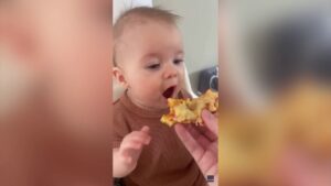 Baby takes first bite of pizza and her reaction is amazing