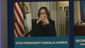 Vice President Harris covers mouth during live broadcast, appears to talk to staff