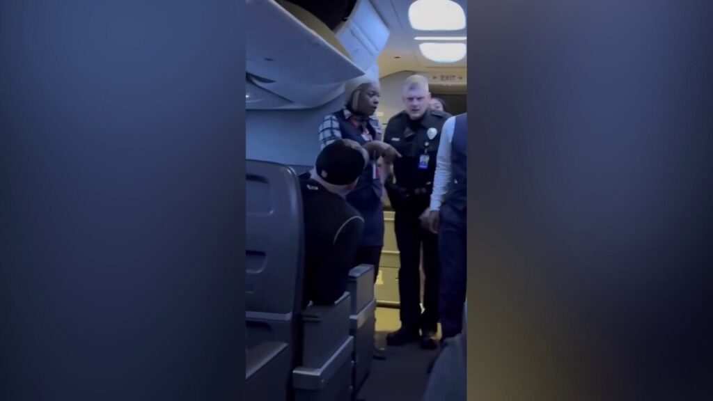 Passengers intervene when a man allegedly becomes violent with a woman seated next to him on a flight