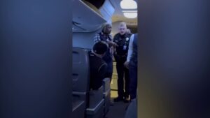 Passengers intervene when a man allegedly becomes violent with a woman seated next to him on a flight