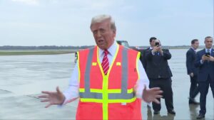 Trump arrives in Wisconsin donning safety vest