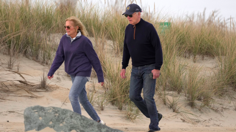 Biden appears to struggle while walking on beach with first lady