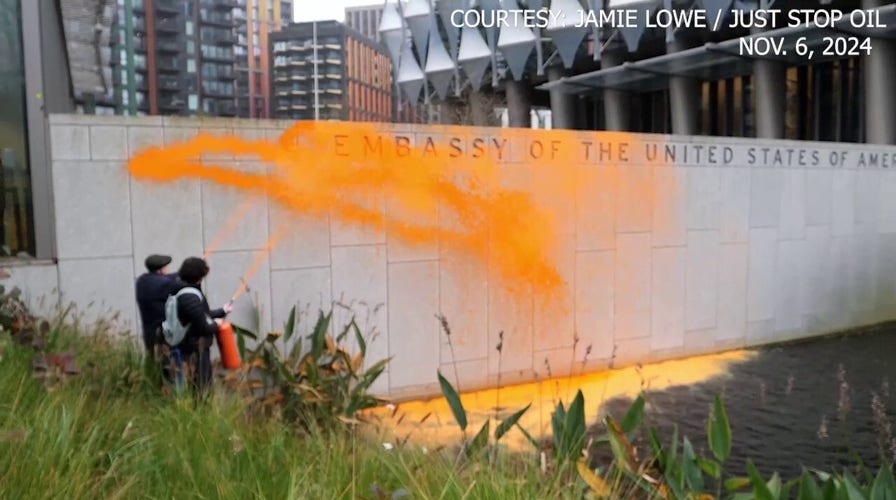 Climate activists spray US embassy in London with orange paint after Trump reelection victory