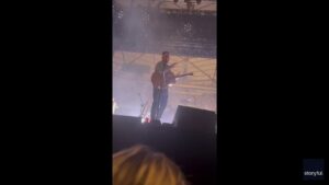 Zach Bryan questions the crowd after someone throws something on stage