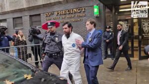 Joshua Zinberg is walked from the 20th Precinct in New York City