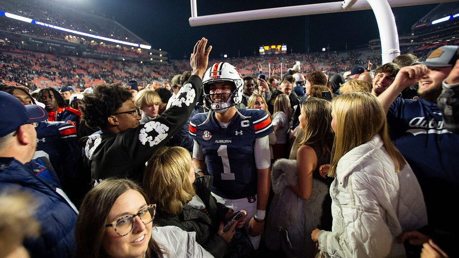 Unranked Auburn upsets CFP-hopeful Texas A&M in 4 OT thriller after game-tying score is dropped