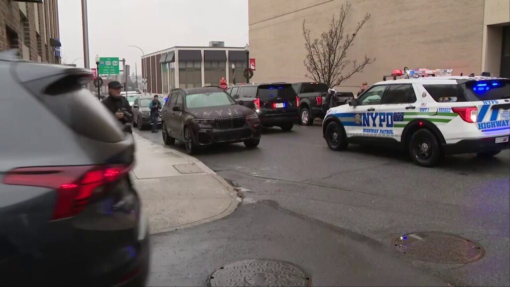 NYPD officials arrive with lights flashing to Pennsylvania police station after CEO murder suspect arrested