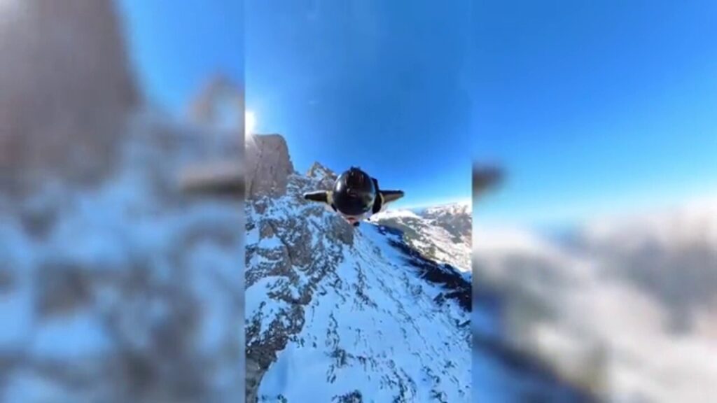 Wing suiter dives from helicopter, soars over stunning Swiss mountains