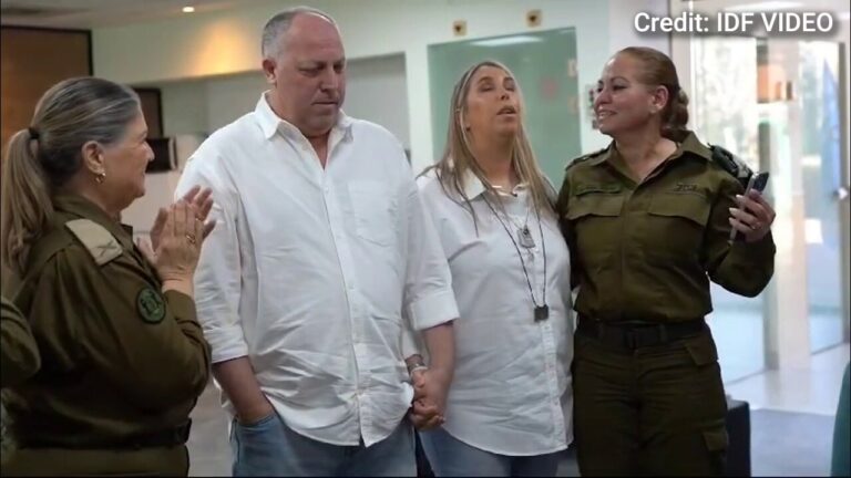 Agam Berger's parents watch as their daughter is transferred from the Red Cross to the IDF