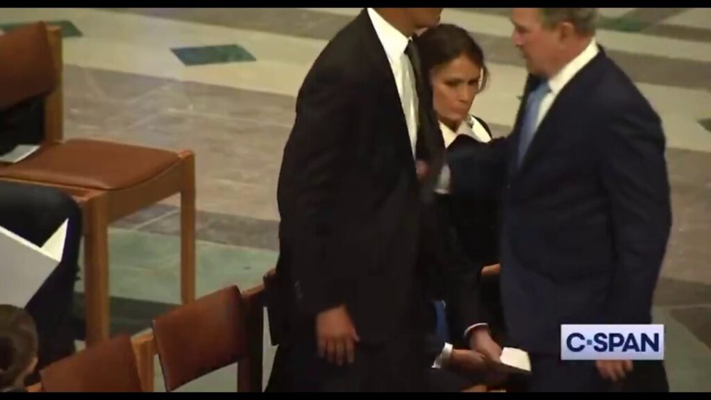 Former Presidents George W. Bush and Obama greet each other at Former President Carter's funeral