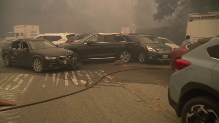 Abandoned vehicles line roadway as Palisades Fire rages