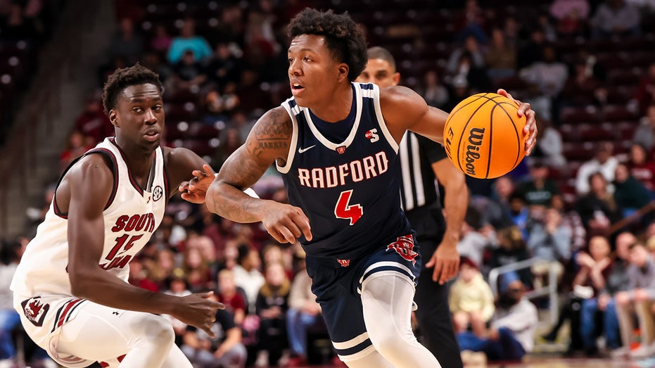 Young college basketball fan delays game after adorably storming the court: ‘Don’t know whose child that is’