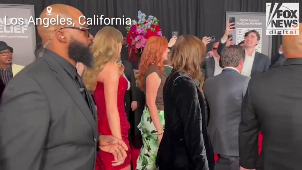 Taylor Swift stuns in a red dress while on the 2025 Grammy Awards red carpet