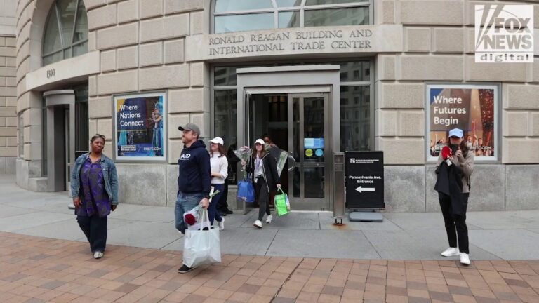 Fired USAID employees leave the headquarters building in Washington, D.C.