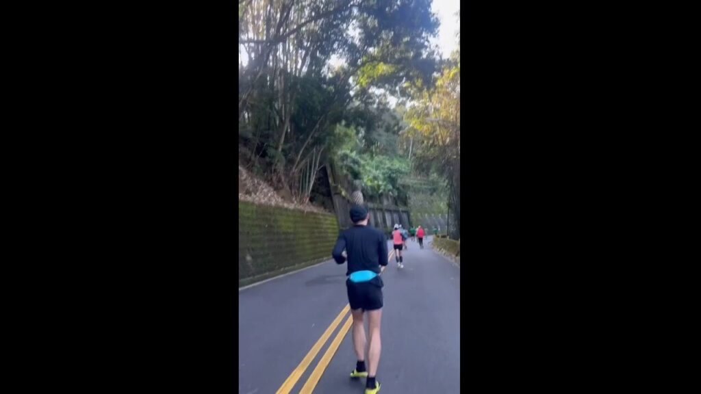 Marathon runner balances pineapple on his head