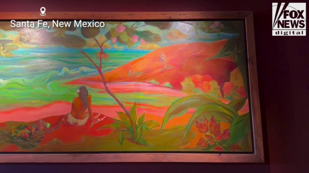 A large portrait of a tropical landscape painted by Gene Hackman hangs in a Santa Fe restaurant