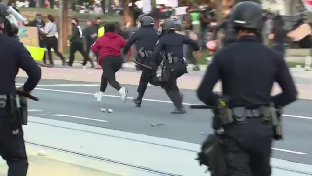 Woman runs from police during anti-ICE protest in Santa Ana