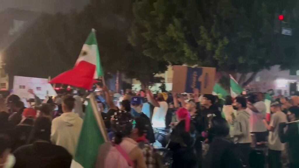 Protestors with Mexican flags shut down street corner in downtown Los Angeles