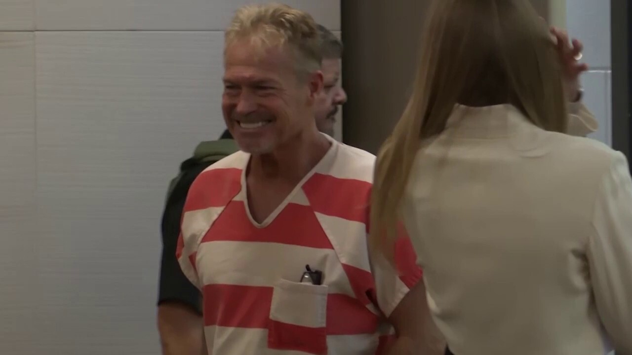Barry Morphew smiles as he enters court