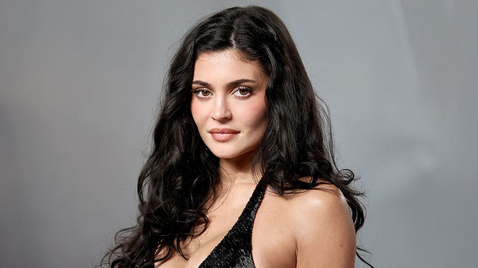 Kylie Jenner poses soaking wet in black bikini for steamy makeup promotional shoot