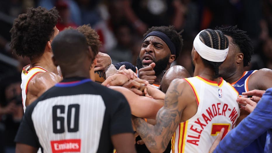 Two players ejected after scrum amid Knicks' 50-point lead against Hawks sends referee crashing to the court